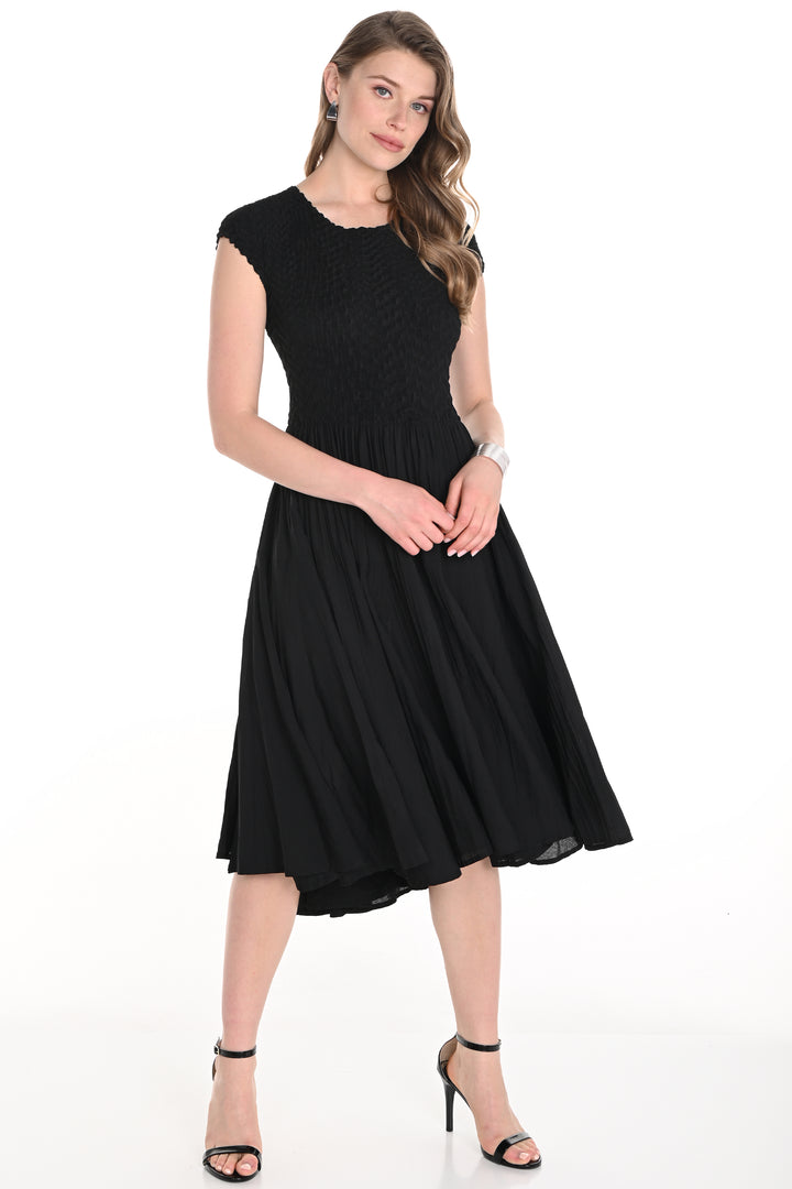 Frank Lyman Spring 2025  The lovely and sleek silhouette features a flare hem that steals the show! The smocked bodice fabric ensures a comfortable and flattering fit, while the contrast top adds a touch of visual interest. 