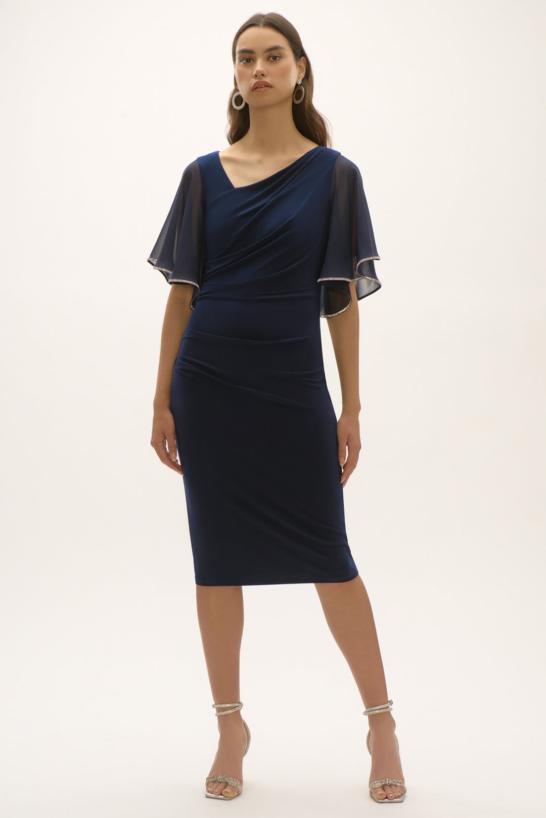 Joseph Ribkoff Spring 2025 The back zipper ensures a perfect fit while the asymmetric v-neck adds a touch of elegance. Add some pleats and a flowing chiffon silhouette, you got an instant splendor of a formal summer dress!