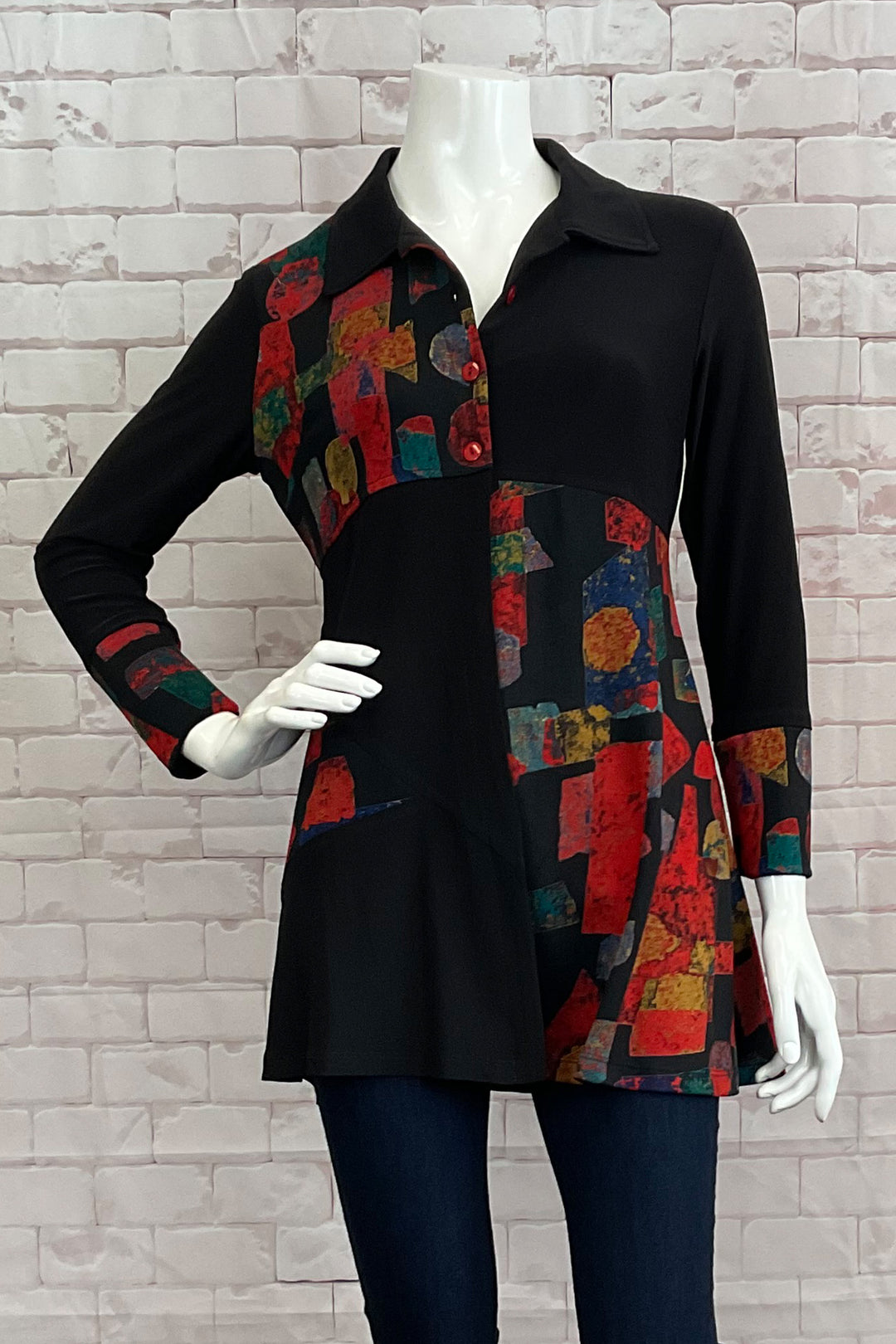 Michael Tyler Fall 2024 Elevate your style with the Mosaic Patchwork Tunic Blouse, designed to capture some attention! This blouse blends traditional elements such as a collar with a unique patchwork design and elegant design cuffs. 