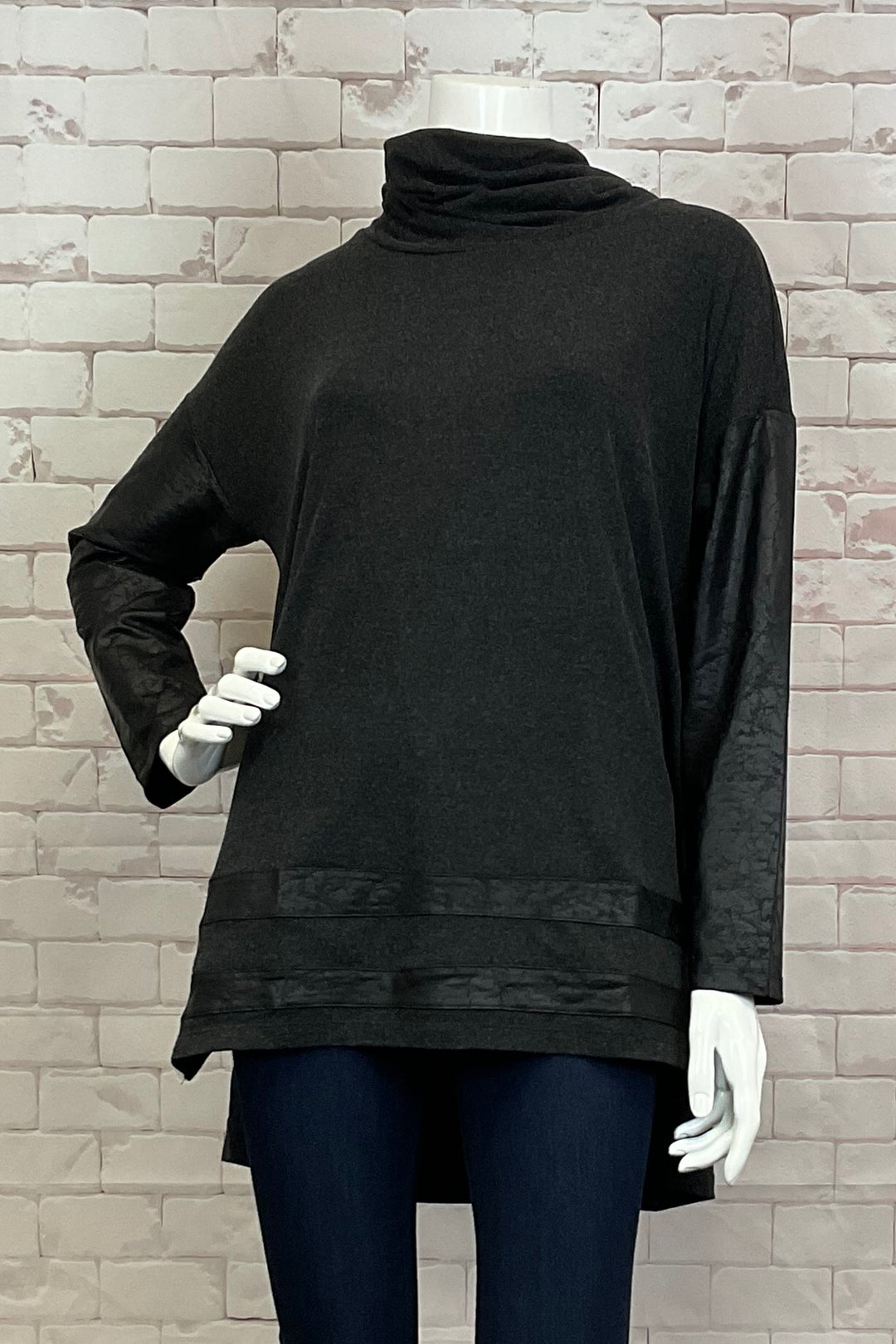 Ever Sassy Fall 2024 This stylish top features a flattering tunic length and a cozy cowl neck, perfect for the upcoming fall season. The crackle fabric texture adds a unique touch to your wardrobe.