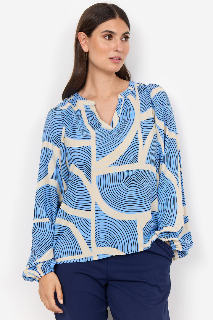 Soya  Concept Summer 2025  Made with 100% viscose, this relaxed to standard fit top features a playful split-neck and full length sleeves. And let's not forget the rad geo abstract print design that adds a touch of wow to any outfit! 