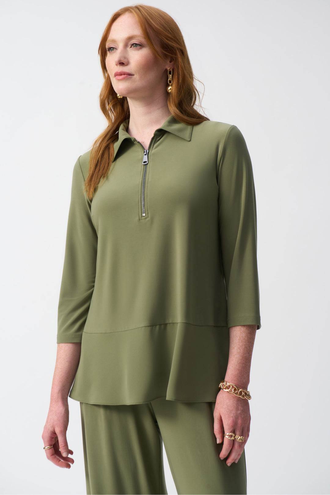 Joseph Ribkoff Spring 2025  Made with a soft blend of fabrics, this tunic offers a light and loose fit for ultimate comfort. Its overall length and classic zip collar add a touch of sophistication, while the slit cut sleeves add a unique, artistic flair! 