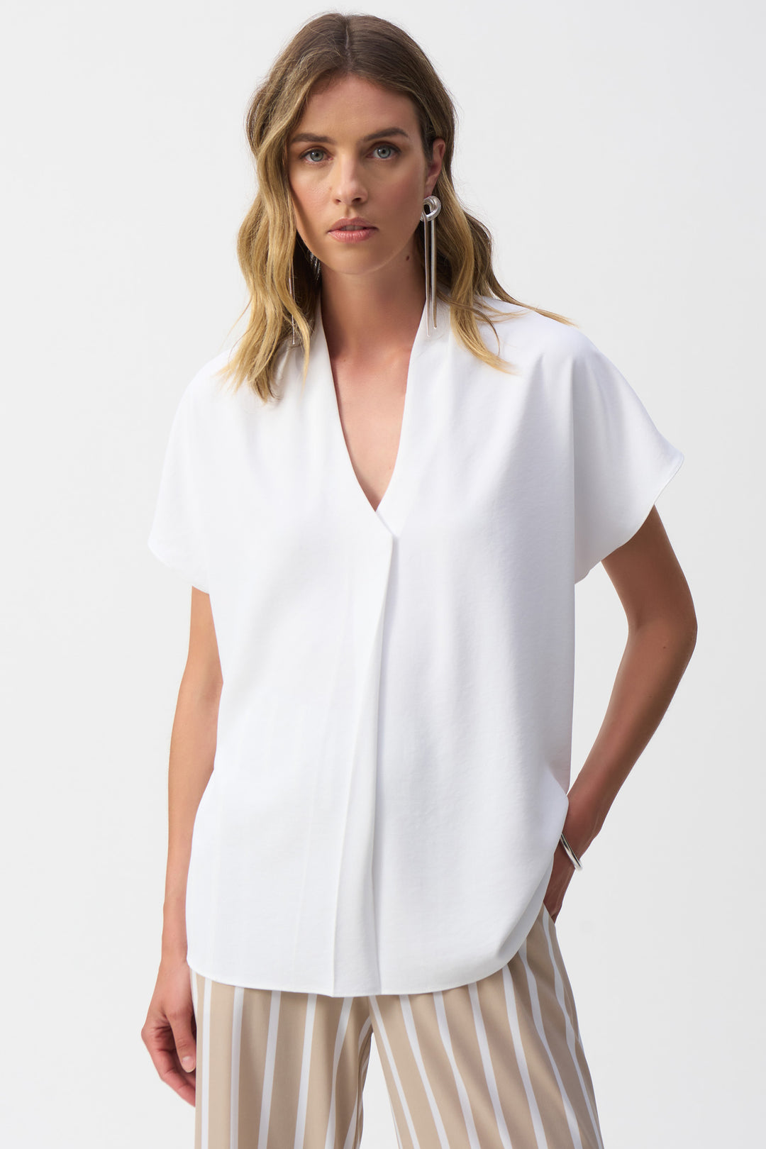 Joseph Ribkoff Spring 2025  With its light and easy feel, silky smooth fabric, and chic casual design, this top is the perfect addition to your wardrobe. Stay comfortable and stylish all day with its soft, breathable material. 