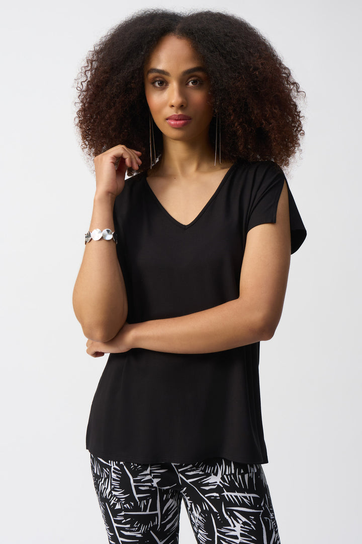 Joseph Ribkoff Spring 2025 Made from ultra soft jersey fabric, this top features unique slit cuts on the sleeves and hem for a touch of edginess.