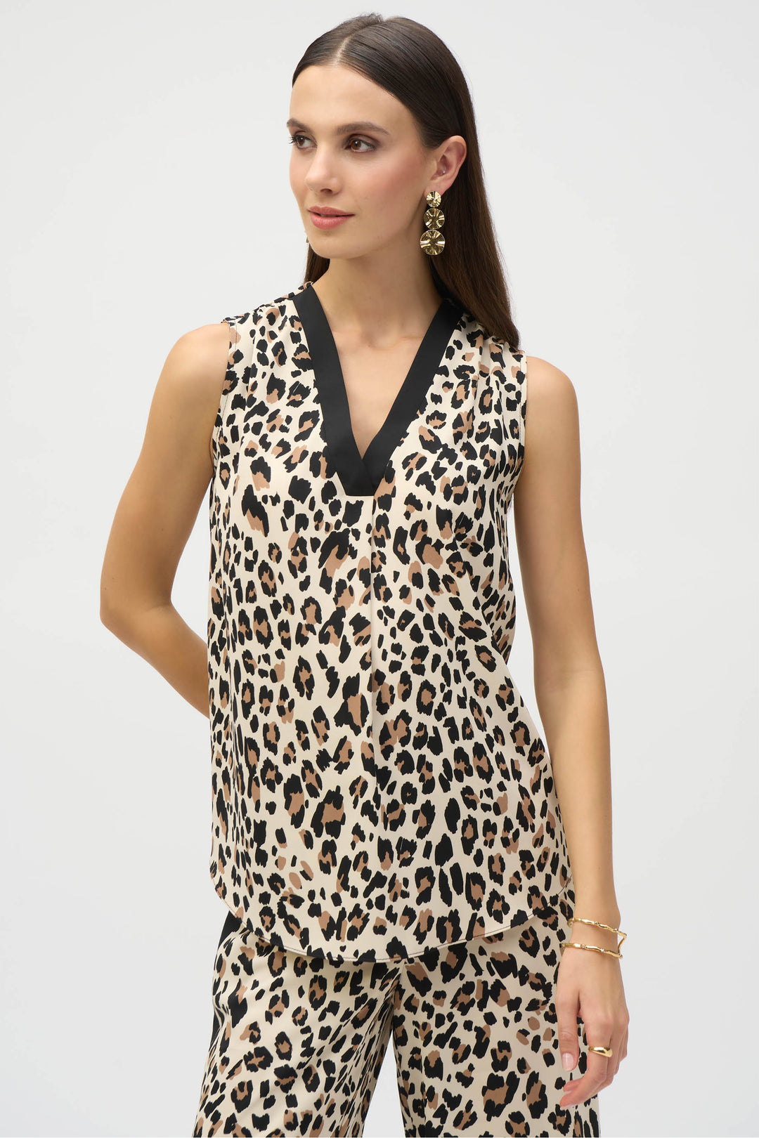 Joseph Ribkoff Spring 2025 The super smooth tiger print adds a touch of ferocity to any outfit, while the bold contrast sharp v-neck and subtle front pleat detail elevate your style.