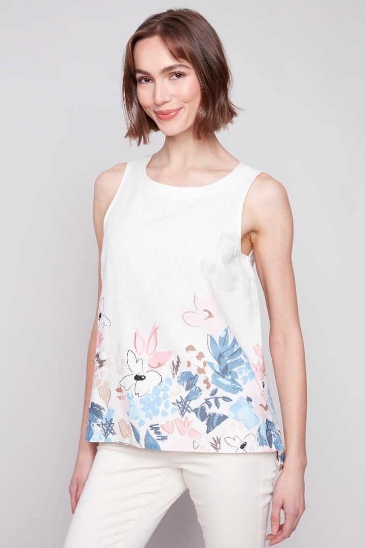 Charlie B Spring 2025 a first for our brand with a new fabric blend of super soft viscose and linen! This top features a contrast floral and plain white pattern on both front and back, adding a touch of fun and whimsy to your wardrobe.