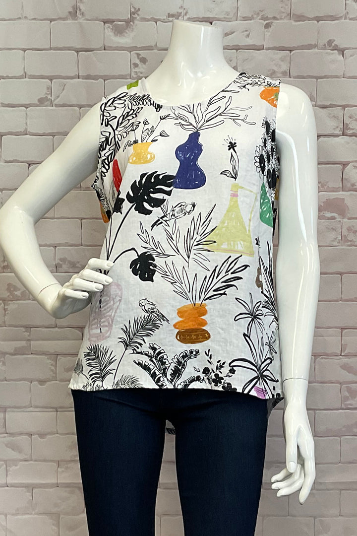 Dolcezza Spring 2025 Featuring a charming floral print and a hi-lo curved hem with a back slit, this top is perfect for pairing with shorts, jeans, or capris.