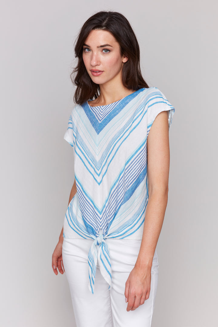 Charlie B Spring 2025 This top features playful cap sleeves and a trendy boat neckline. The mitre stripe print pattern adds a unique touch, while the tie knot at the hem keeps things interesting.