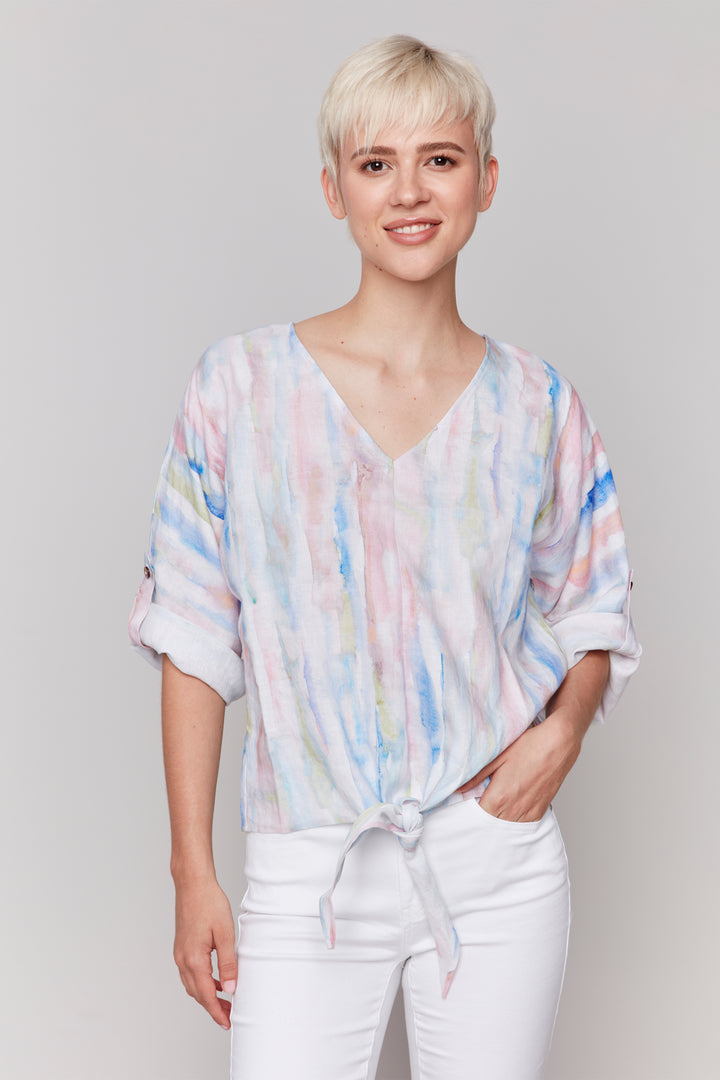 Charlie B Spring 2025  Featuring a stunning print and playful tie knot front hem, this top will add a pop of colour to any outfit. With dolman 3/4 roll up sleeves -shorts or capris. 