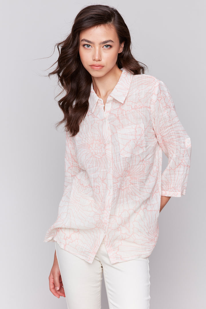 Charlie B Spring 2025 This cotton gauze top features a light and breezy design, perfect for any summer day. The full button closure and chest pocket add a touch of functionality, while the 3/4 length sleeves and classic collar exude elegance.