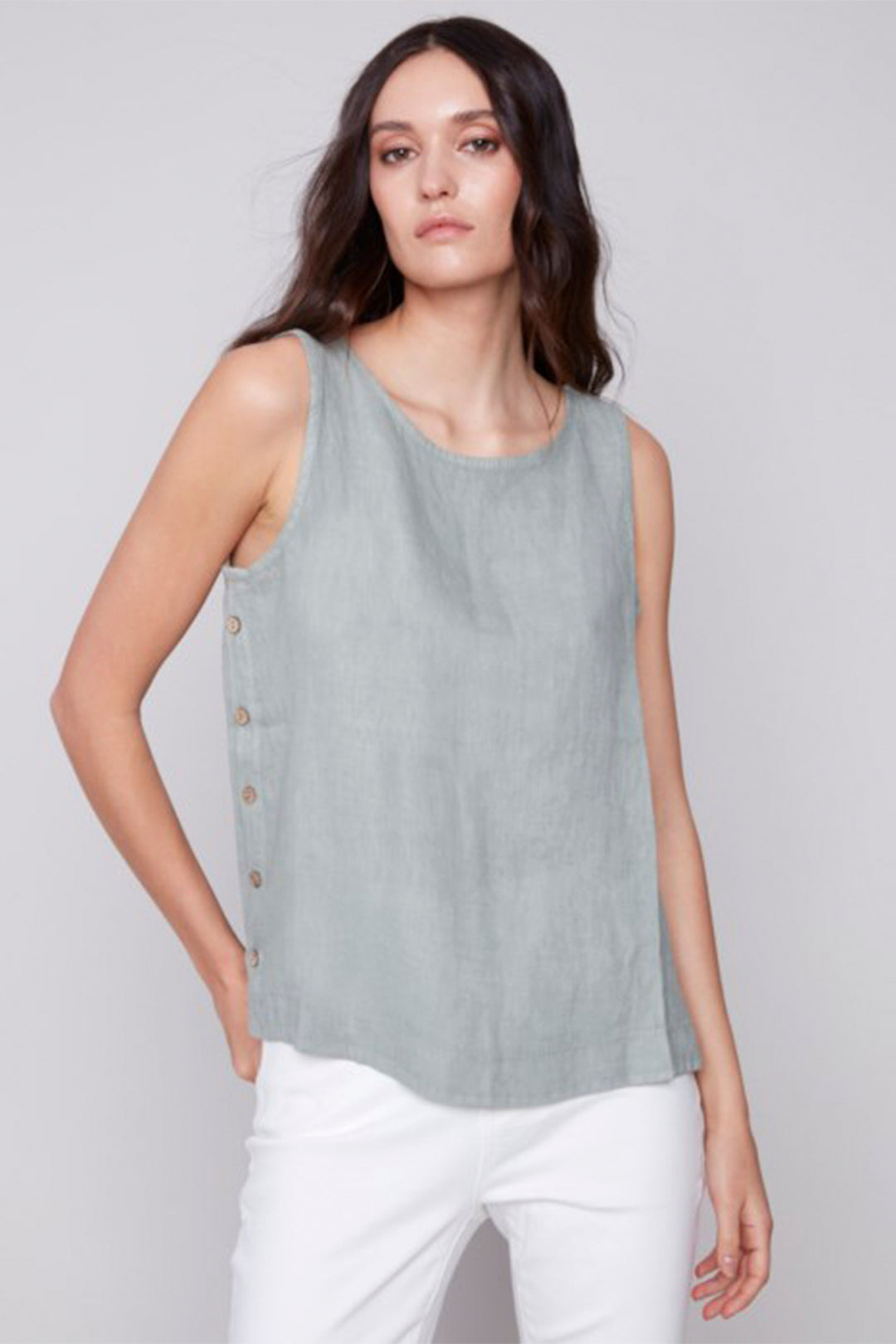 Charlie B Spring 2025  This effortless and comfortable side button sleeveless top is the perfect addition for your summer wardrobe. It's side button detail will give an outfit that something extra to make it go from basic to fresh! 