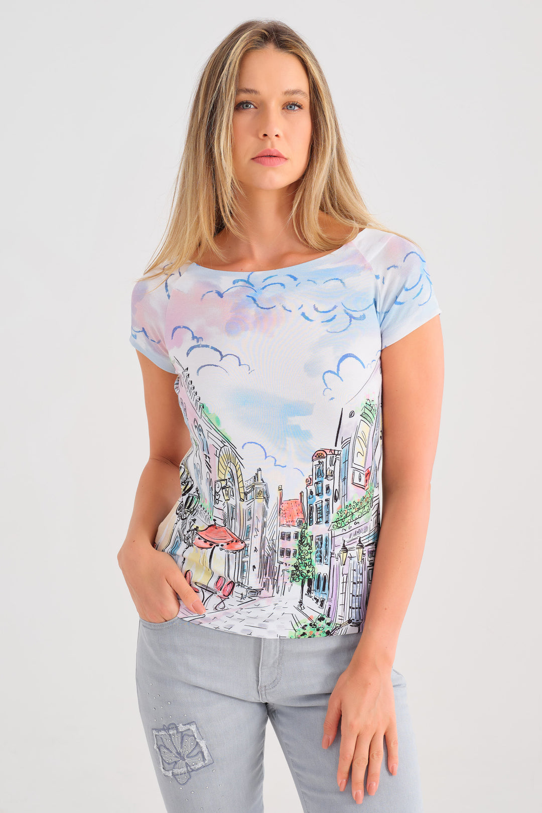 Dolcezza Spring 2025 This top boasts an eye-catching fun summer Parisian artsy print, short sleeves and an overall crisp clean feel.