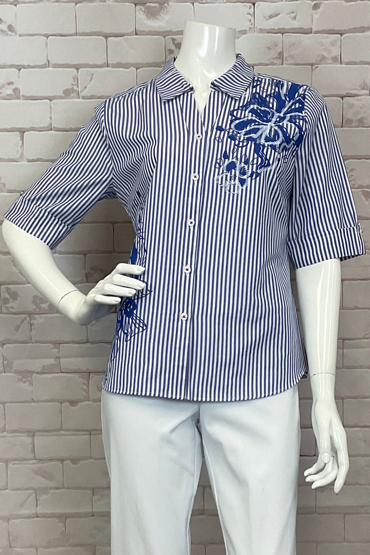 Dolcezza Spring 2025 This stunning blouse features a blue and white stripe design, a round hemline and a back pleat for a flattering fit. The half length sleeves and red stitch contrast cute buttons add a touch of elegance to this dress shirt blouse.