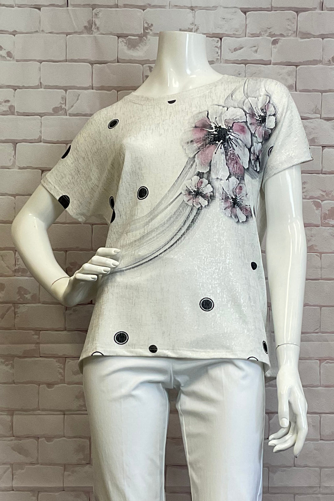 Ness Spring 2025  The round neckline and short sleeves make it easy and comfortable to wear, while the pink and black floral print with dots on the front adds a touch of fun and playfulness to any outfit. 