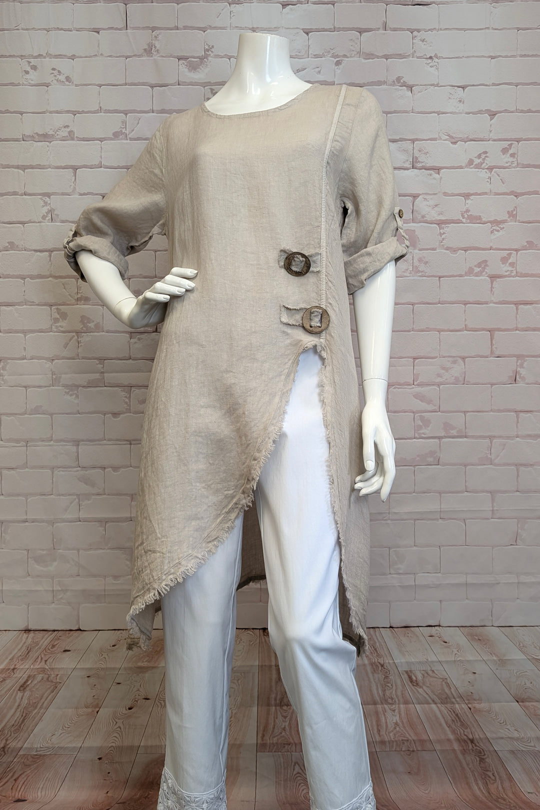 CHRSH Spring 2025 Featuring playful button tab cuff sleeves and a neat ruffle edge hem that adds just the right amount of fun. The side cut open slit gives you freedom to move, while two front buttons keep things interesting.