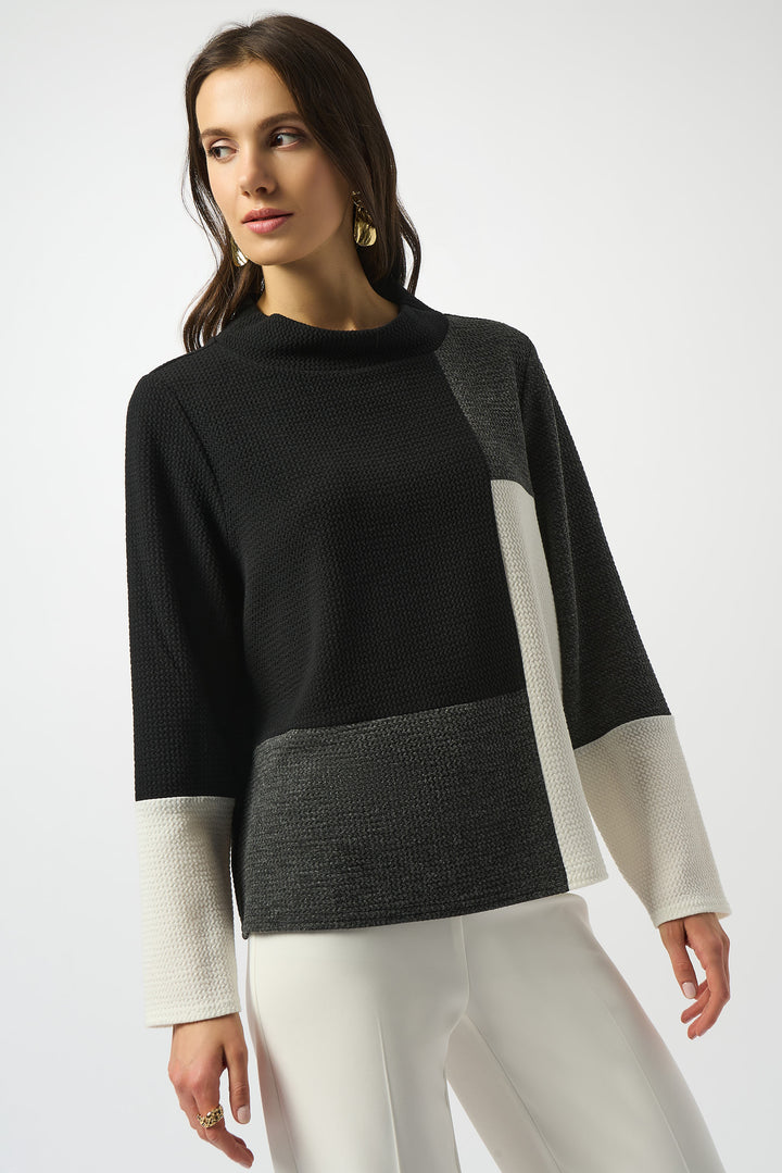 JOSEPH RIBKOFF Fall 2025 This light sweater top is designed and made in Canada and features a mock neck and long dolman sleeves. Designed with a colour block pattern, this pullover allows you to make a bold statement.