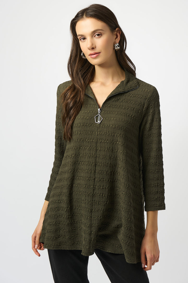 Joseph Ribkoff Fall 2025 
Featuring a lighter, looser fit and 3/4 length sleeves, it offers comfort without compromising elegance. The zipper neck adds a contemporary edge, while the textured knit fabric provides subtle visual interest, making it ideal for both office settings and casual outings.