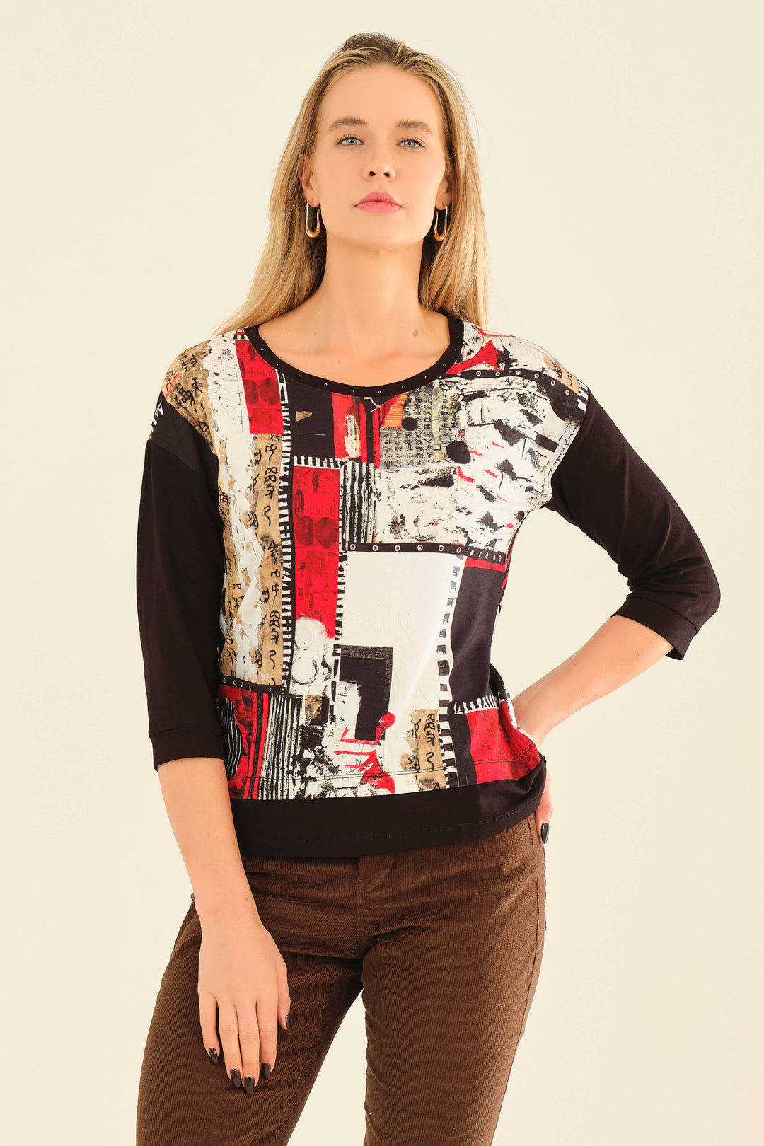 Dolcezza Fall 2025 
Its neat drop shoulder seams create a more relaxed fit, while the abstract geometric print adds a modern touch. Featuring a round neck accented with studs and bold contrast hem, this top stands out with subtle details.