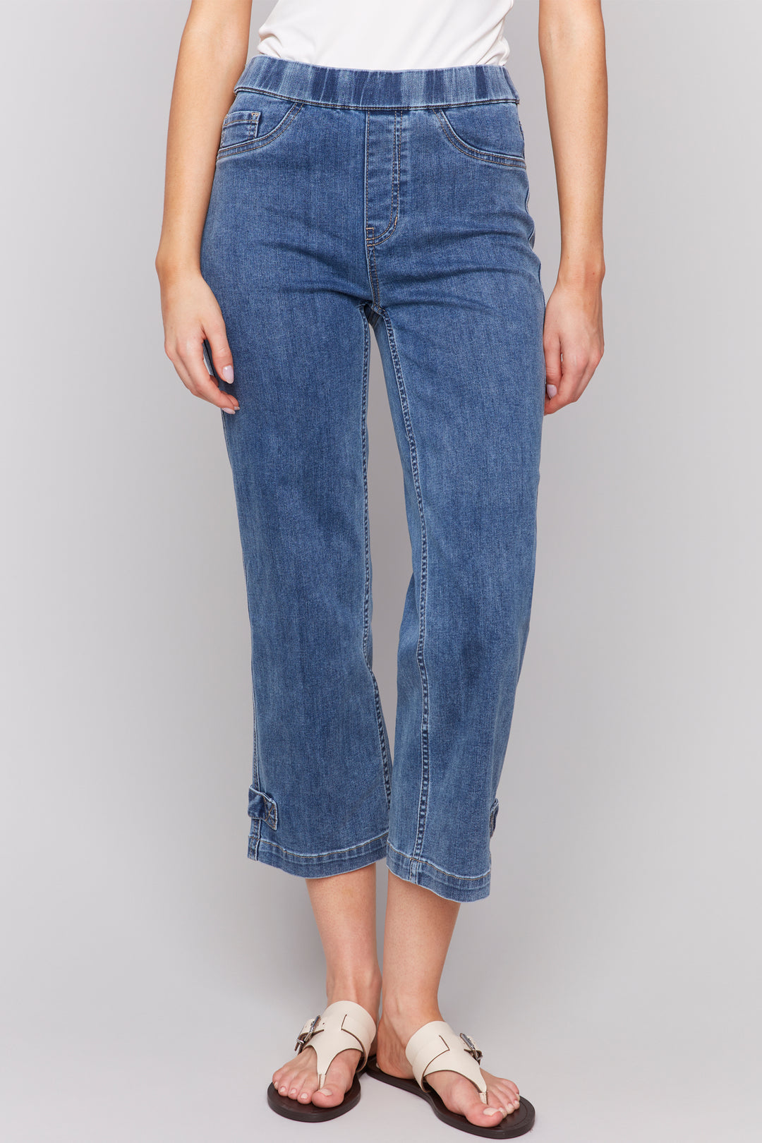 Charlie B Spring 2025 Expertly crafted with a classic 5 pocket design, our Crop Jean With Tab Hem offers a cropped length and regular fit for a chic and versatile look this season.