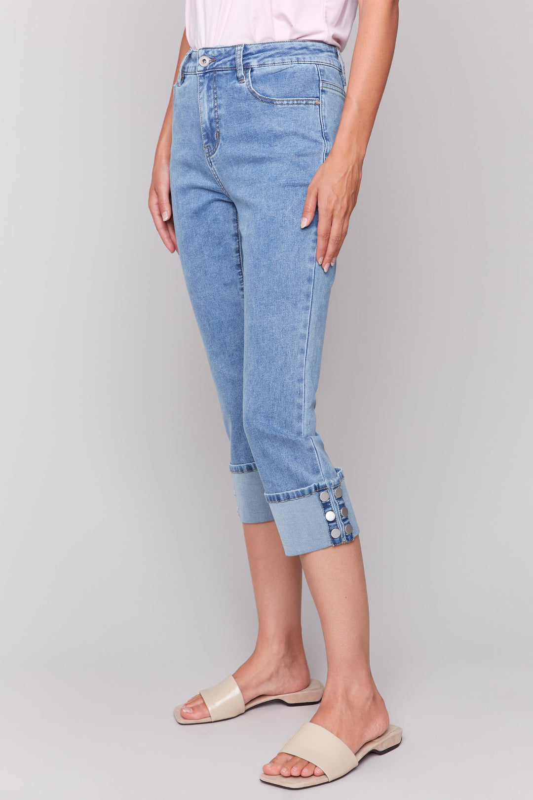 Charlie B Spring 2025  Expertly crafted with a classic 5 pocket design, our snap jean offers a cropped length and regular fit for a chic and versatile look this season. 