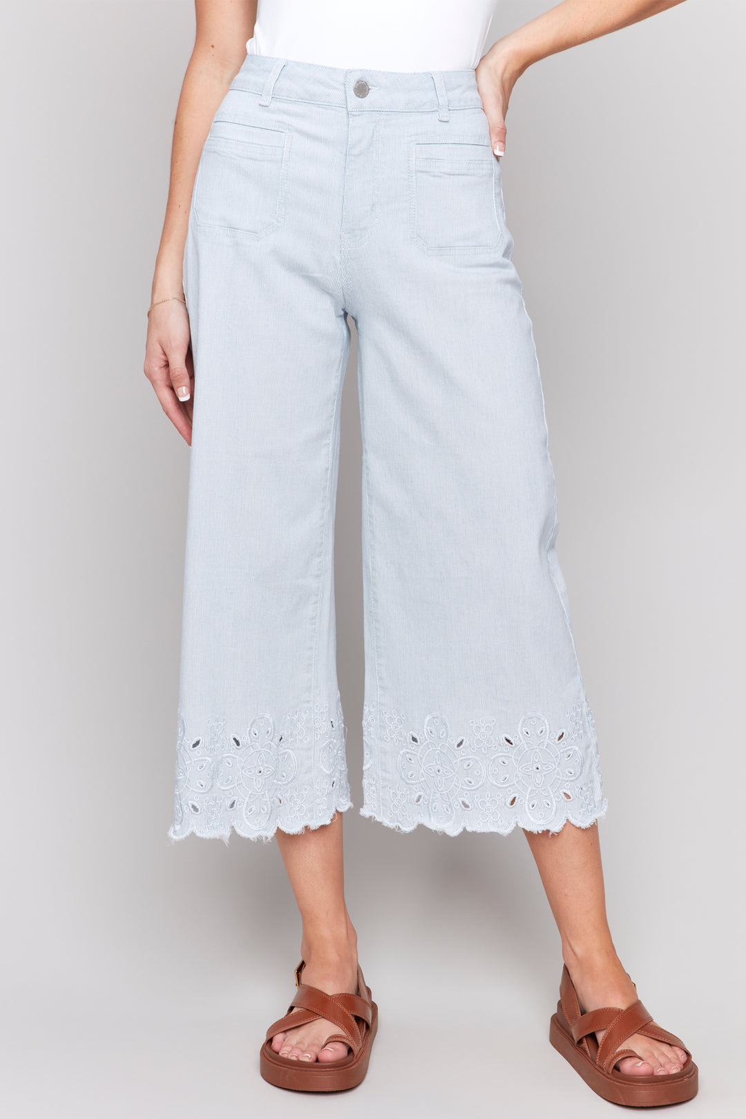 Charlie B Spring 2025 The frayed scallop embroidered hem adds a playful touch to these classic wide-leg jeans, while the zipper fly & belt loops provide the perfect fit.