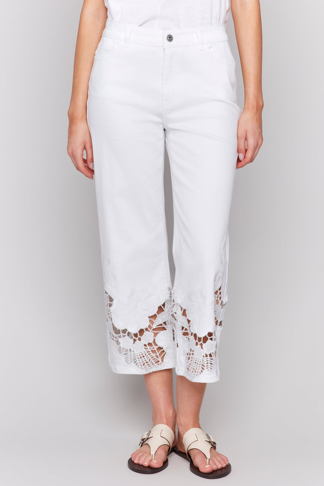 Charlie B Spring 2025 The embroidered lace hems adds a playful touch to these classic flare leg jeans, while the zipper fly &amp; belt loops provide the perfect fit.