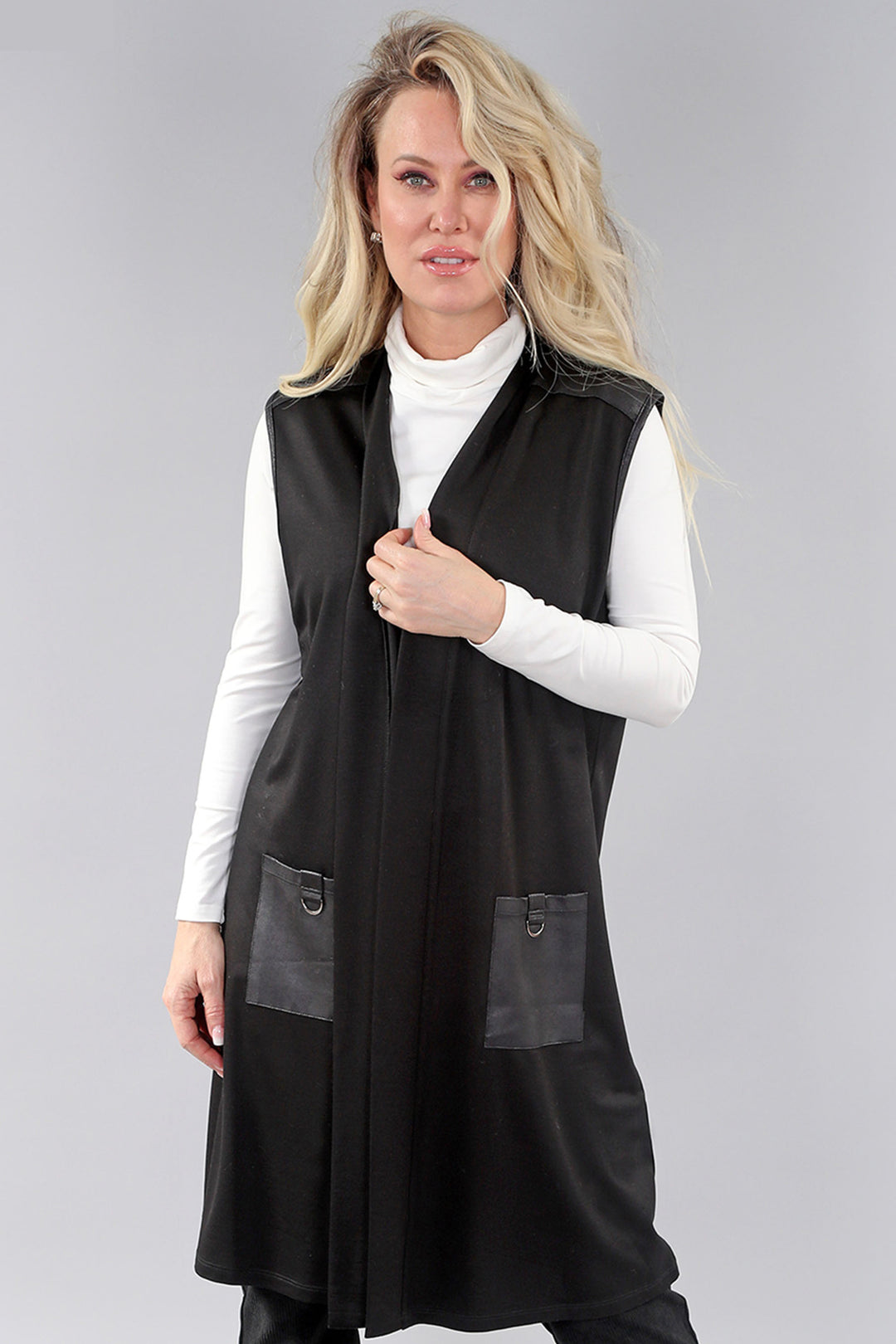 Michael Tyler Fall 2024 Elevate your style with our Black Vest, featuring long open cardigan style and faux leather crinkle patch pockets. Light and loose, it's perfect for layering and adds a touch of edgy sophistication. 