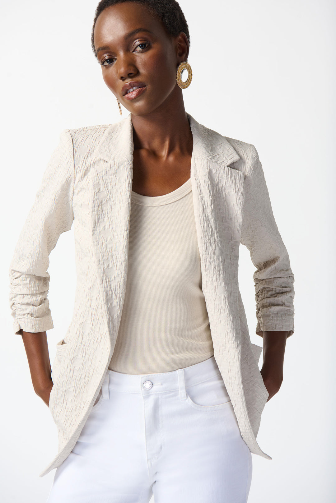 Joseph Ribkoff Spring 2025  The unique textured fabric design adds a touch of elegance to any outfit. Its free-flowing and light material makes it perfect for many spring and summer days, while the longer length and side pockets add functionality. 