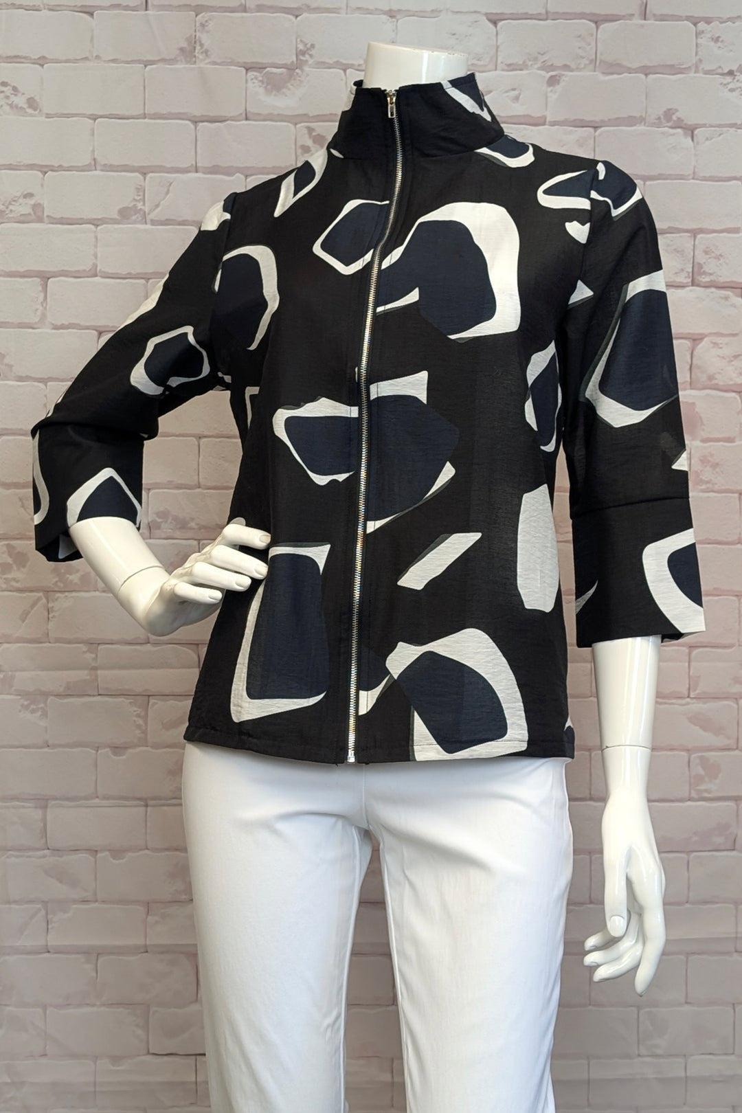 VARIATIONS Spring 2025  Crafted with 3/4 cuffed sleeves and a front zipper with a high collar, this stunning trapeze jacket boasts a geometric print to create volume and dimension overall. 