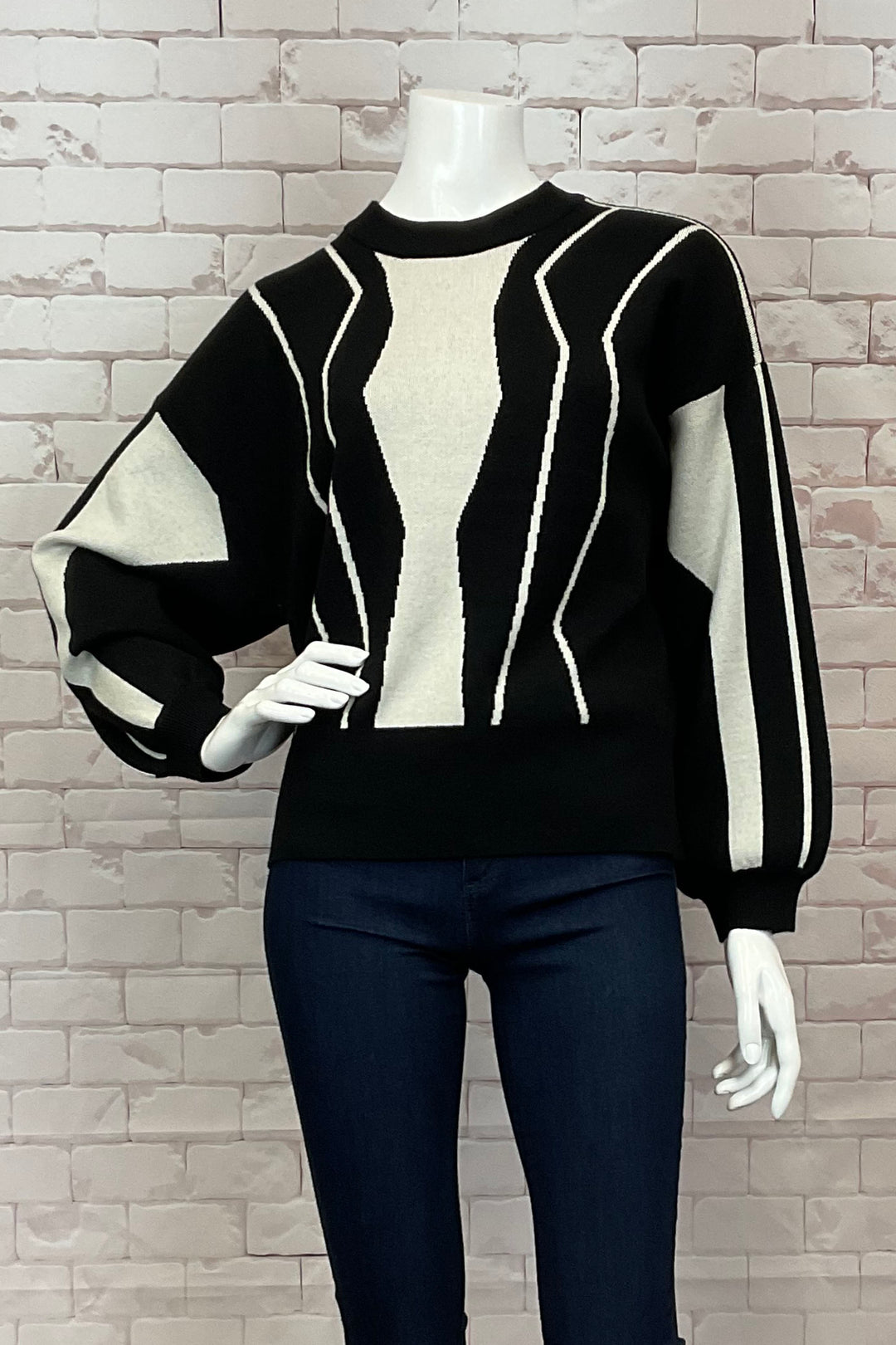 B. Young Fall 2024  Made from soft and light fabric with 'pinched' cuffs, this neat pullover features a stunning geo linear print and loose dolman sleeves. 