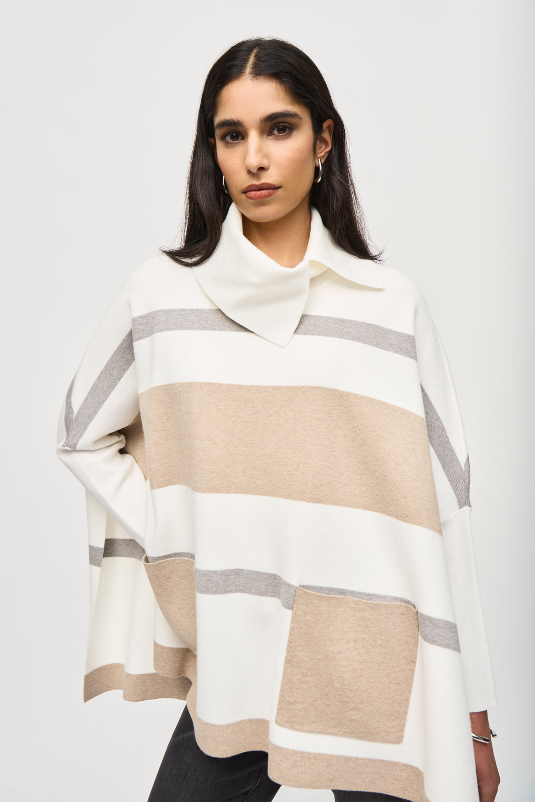 Joseph Ribkoff Fall 2024 Its trendy knit design features a classic stripe print, a 'twisted' cowl neck and a front large patch pockets.