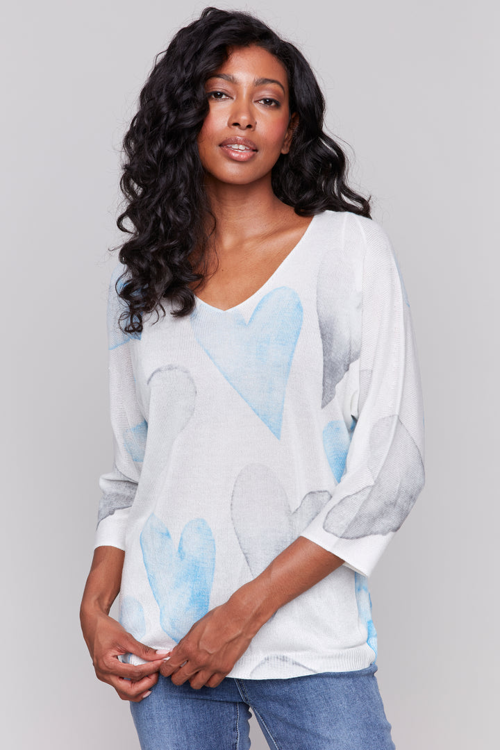 Charlie B Spring 2025 Featuring a soft cut v-neck and classic dolman sleeves, this charming heart print will add a playful touch to your wardrobe.