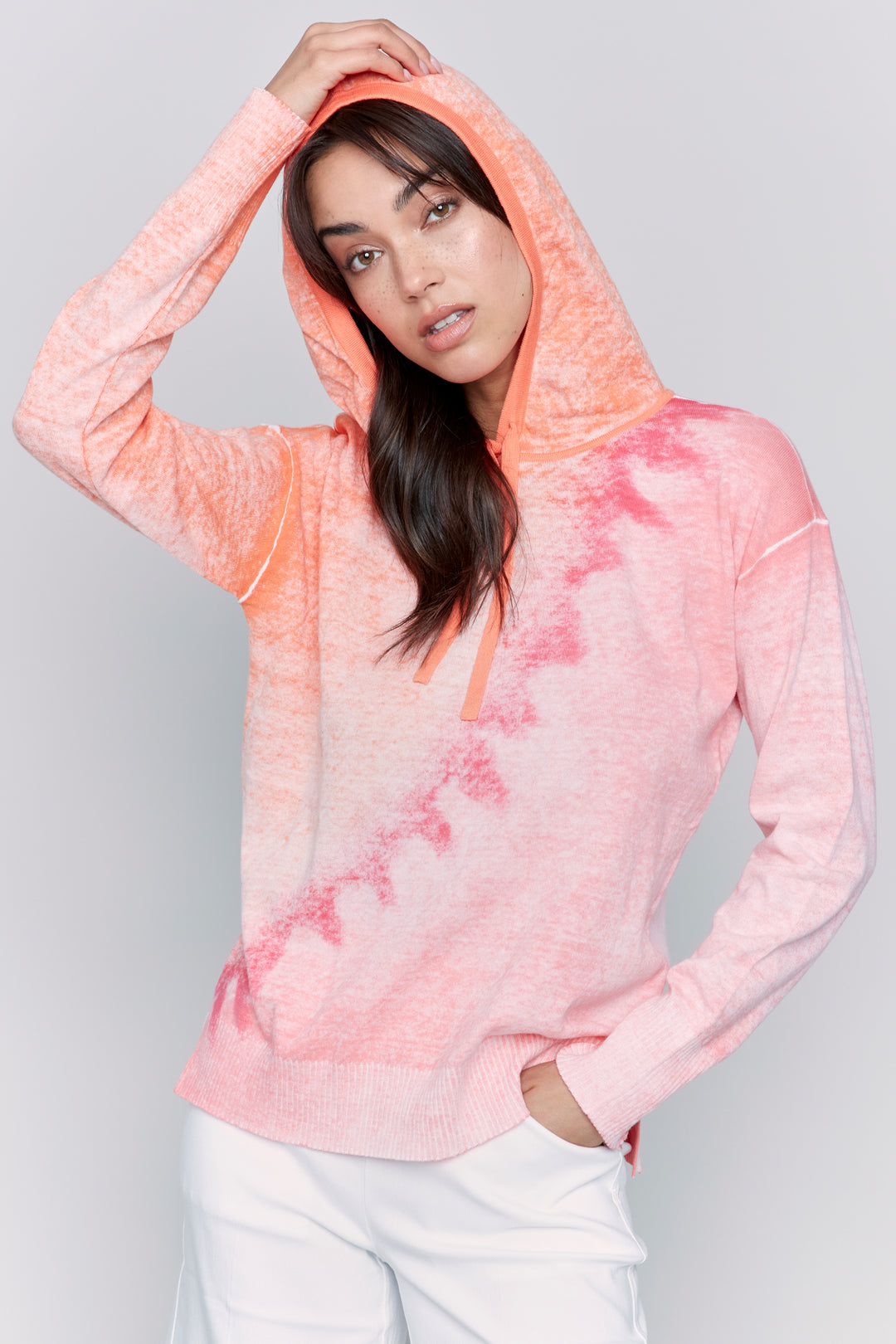 Charlie B Spring 2025  Made with all-natural cotton fabric, this reversible top features a drawstring hood and an eye-catching warm design. 