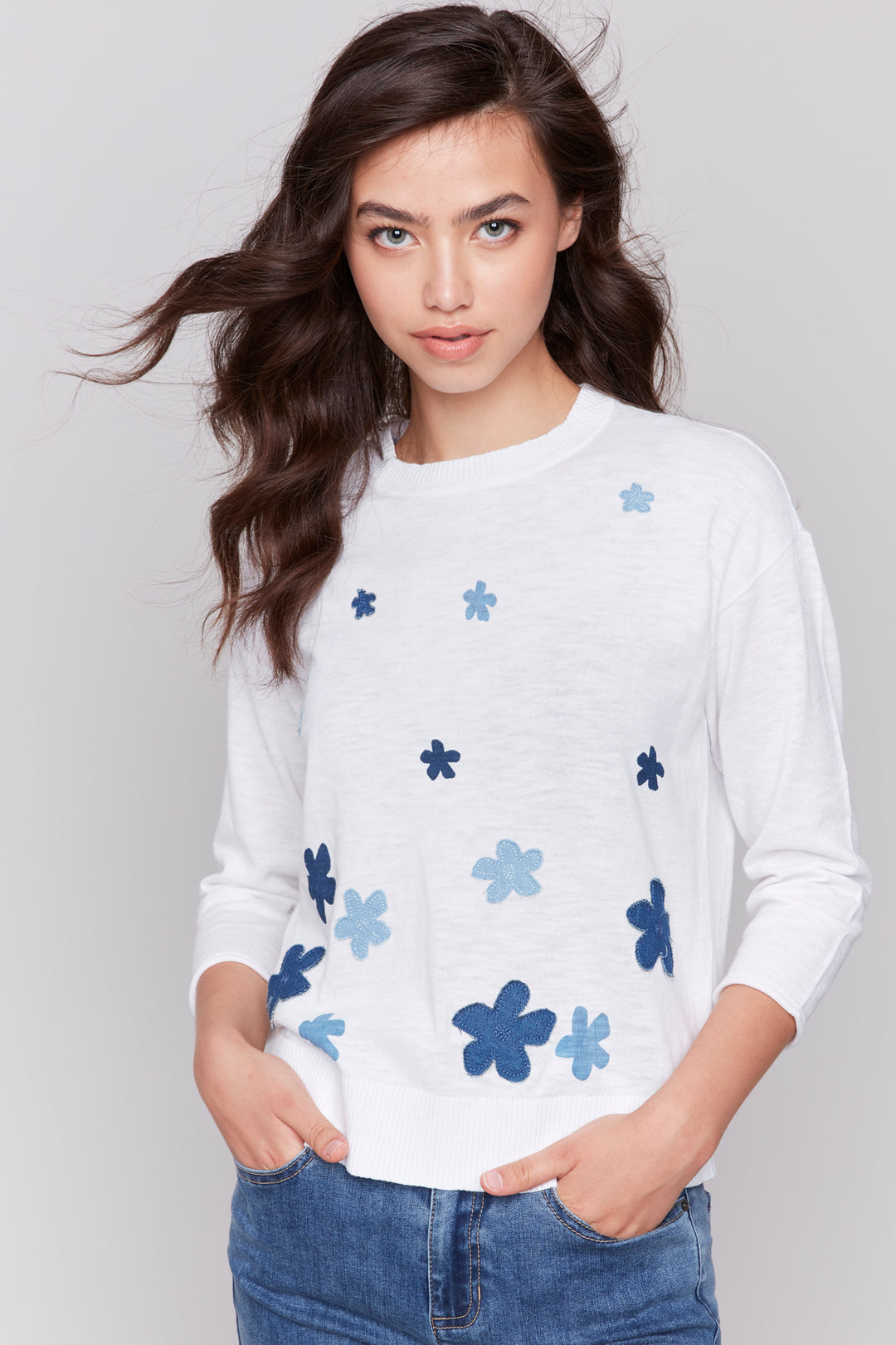 Charlie B Spring 2025  It features neat patch appliques, a crew neckline, high low hem and three-quarter length sleeves. 