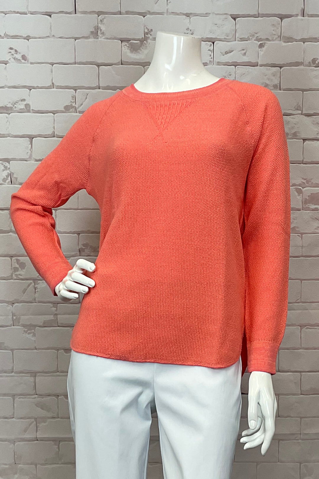 Cotton Country Spring 2025 The Skyler Sweater Top is a stylish and comfortable light sweater, made from all cotton. It features a unique raglan shoulder detail as well as a shirttail hem on both the front and back.