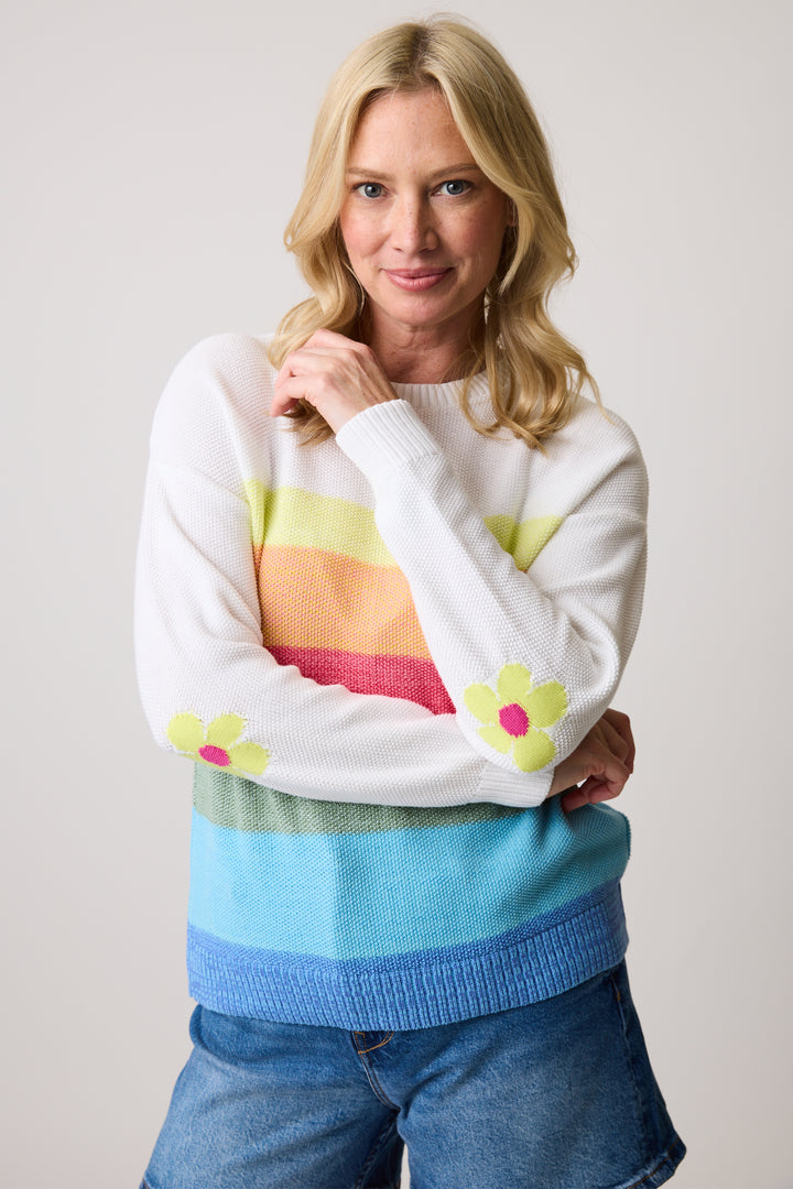 Cotton Country Spring 2025 This colorful top features thick stripes, a crew neck, and a ribbed hem for a cozy fit. The knit fabric is perfect for cooler spring days.