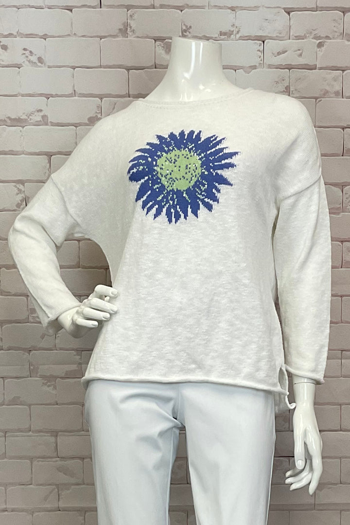 Cotton Country Spring 2025 This cute knit cotton light sweater top is sure to make a statement this spring and summer!&nbsp; So standout with a rolled hem, cropped straight sleeves with a slight boat neckline with a cheerful flower embroidered into the centre of the sweater.