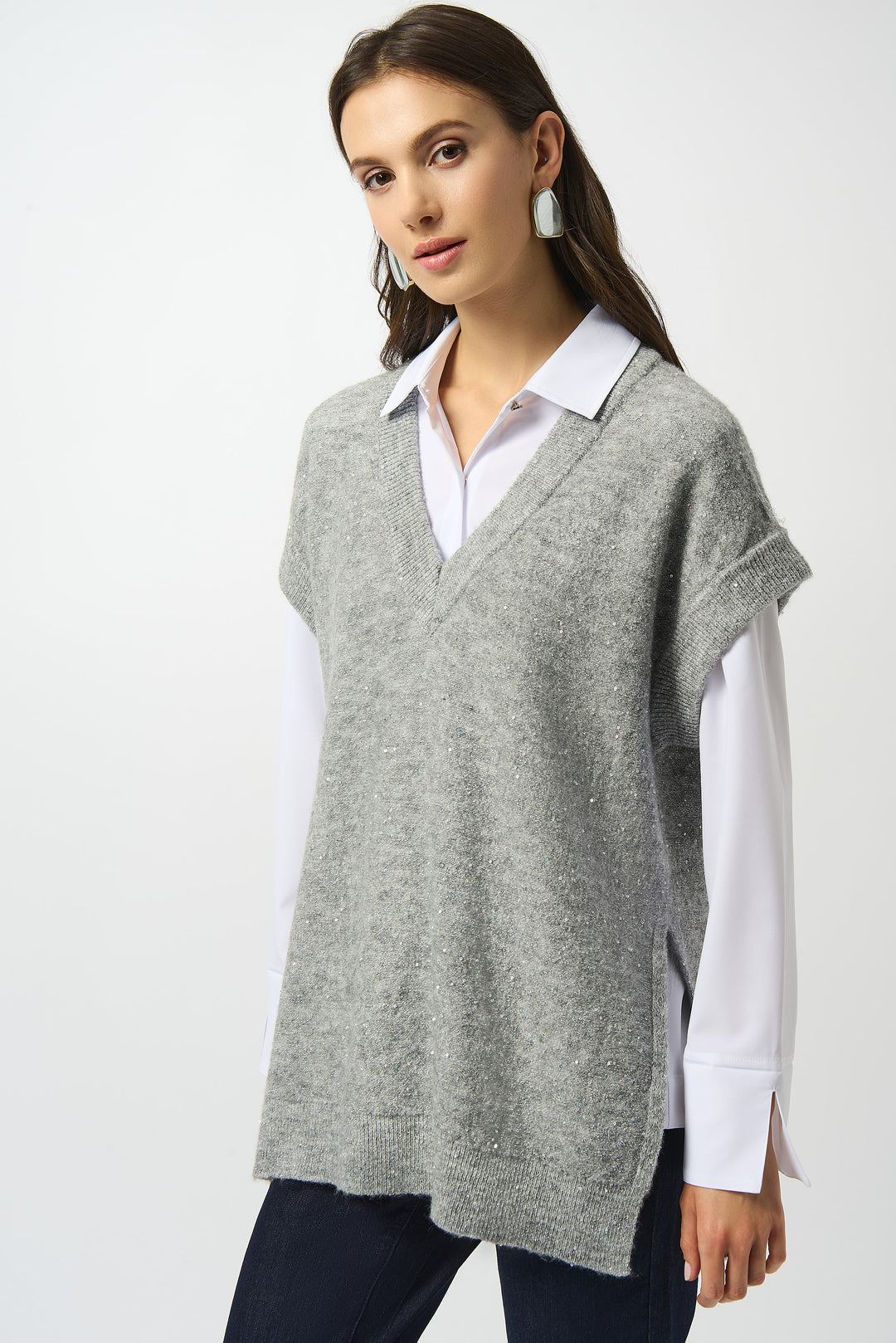 Joseph Ribkoff Fall 2025 
The contrast V-neck and cuffs add a polished touch, making it perfect for layering over a blouse or classic dress shirt. Combining chic style with effortless comfort, it elevates any outfit with subtle sparkle and timeless appeal.