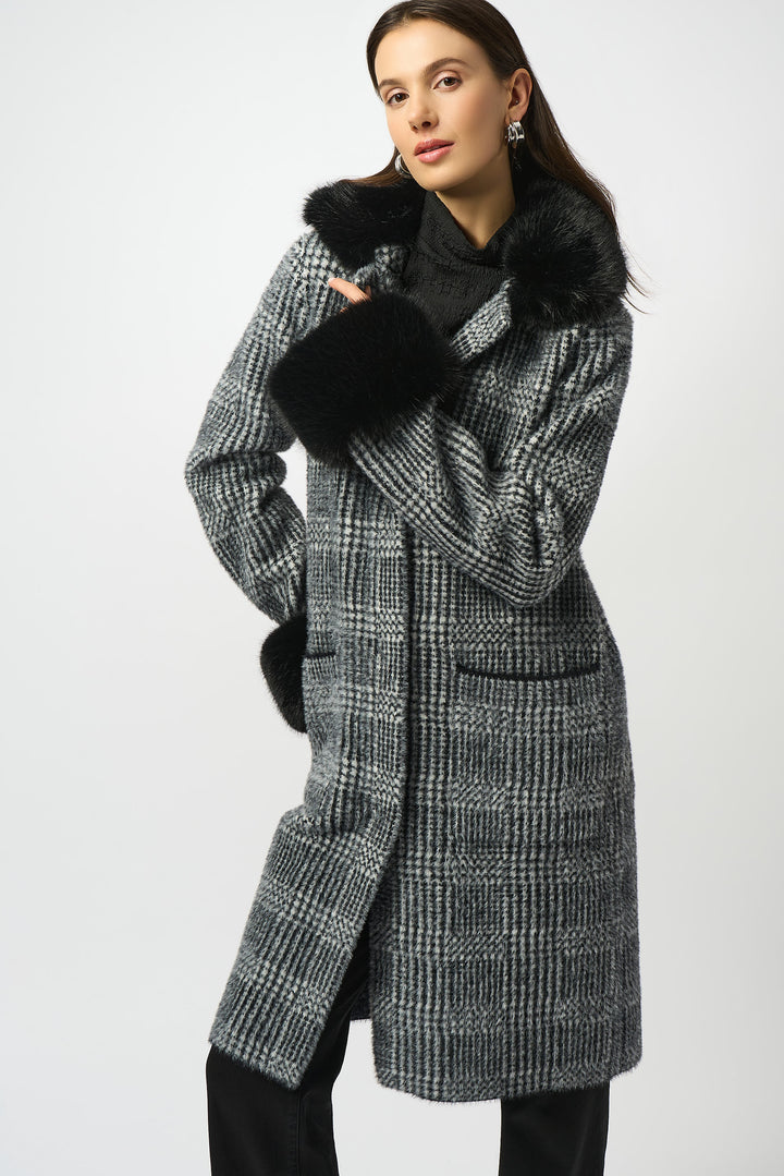 Joseph Ribkoff Fall 2025 Made with soft feather yarn and a warm faux fur neckline and cuffs, this sweater knit coat also features convenient side pockets.