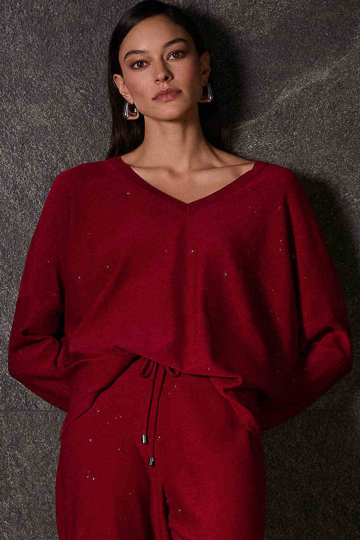 Joseph Ribkoff Fall 2025 
 The light sweater top features a smart v-neck and a relaxed fit, making it both comfortable and stylish. Pair it with the matching glitter wide-leg pant for a sleek and eye-catching look today! 