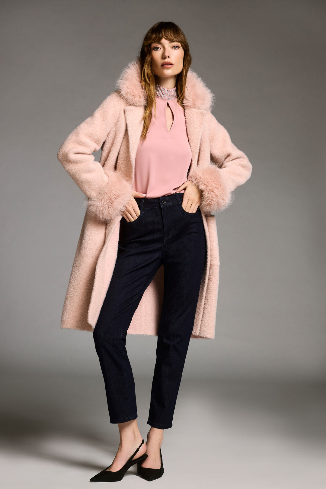 Joseph Ribkoff Fall 2025 
Made with soft feather yarn and a warm faux fur hood, this sweater knit coat also features convenient side pockets.