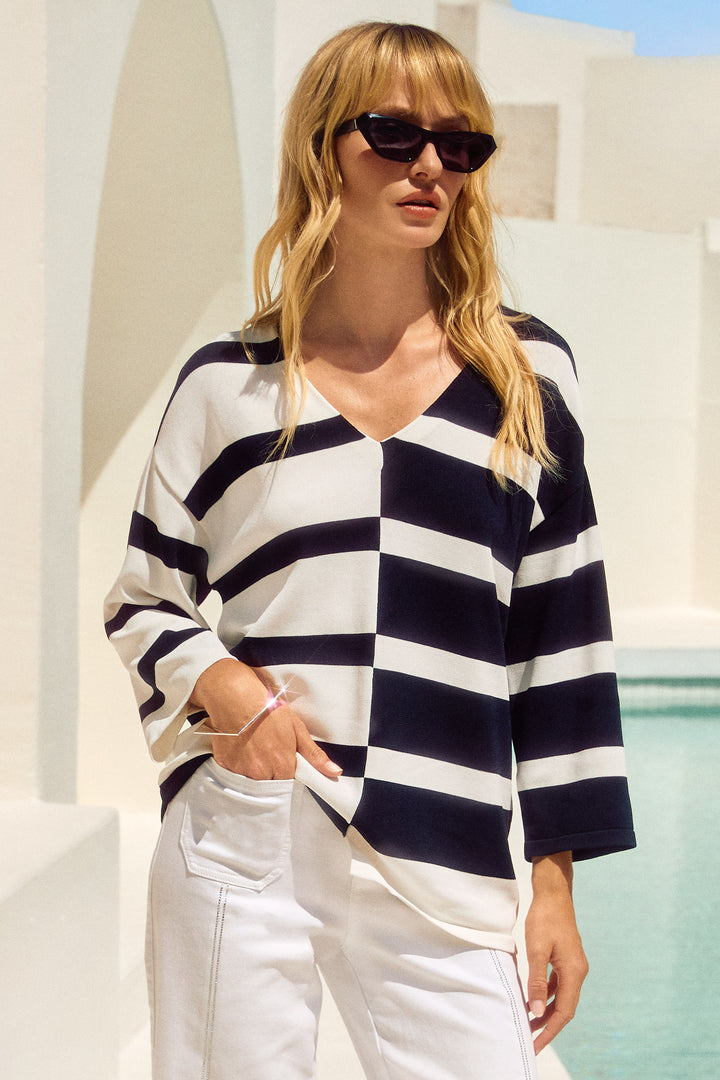 Joseph Ribkoff Summer 2025  Made with a soft blend of fabrics, this top is breathable and comfortable to wear. The geometric stripe print adds a touch of style to any outfit. 