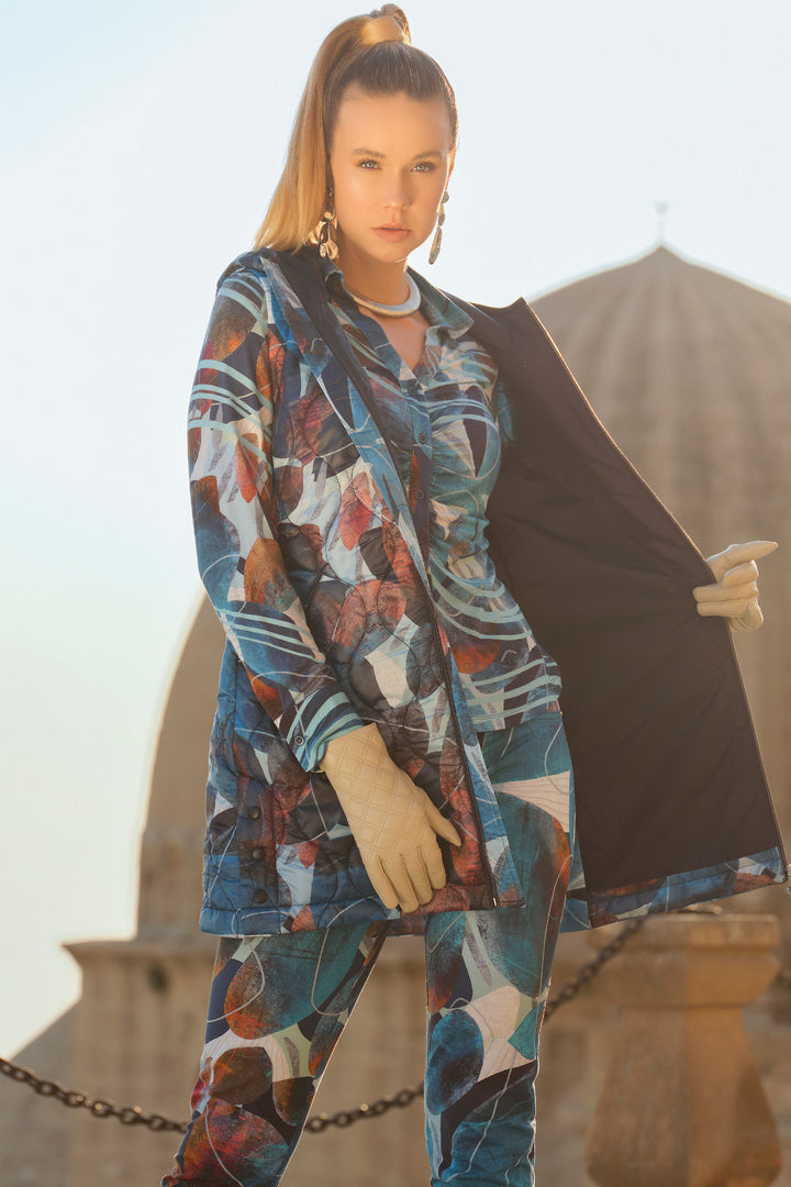 Dolcezza Fall 2024  The light sheen and smooth, quilted material will keep you warm and comfortable. Featuring a longer length, hood, two front pockets, side hem buttons and a trendy blue floral design in fall and winter colours. 