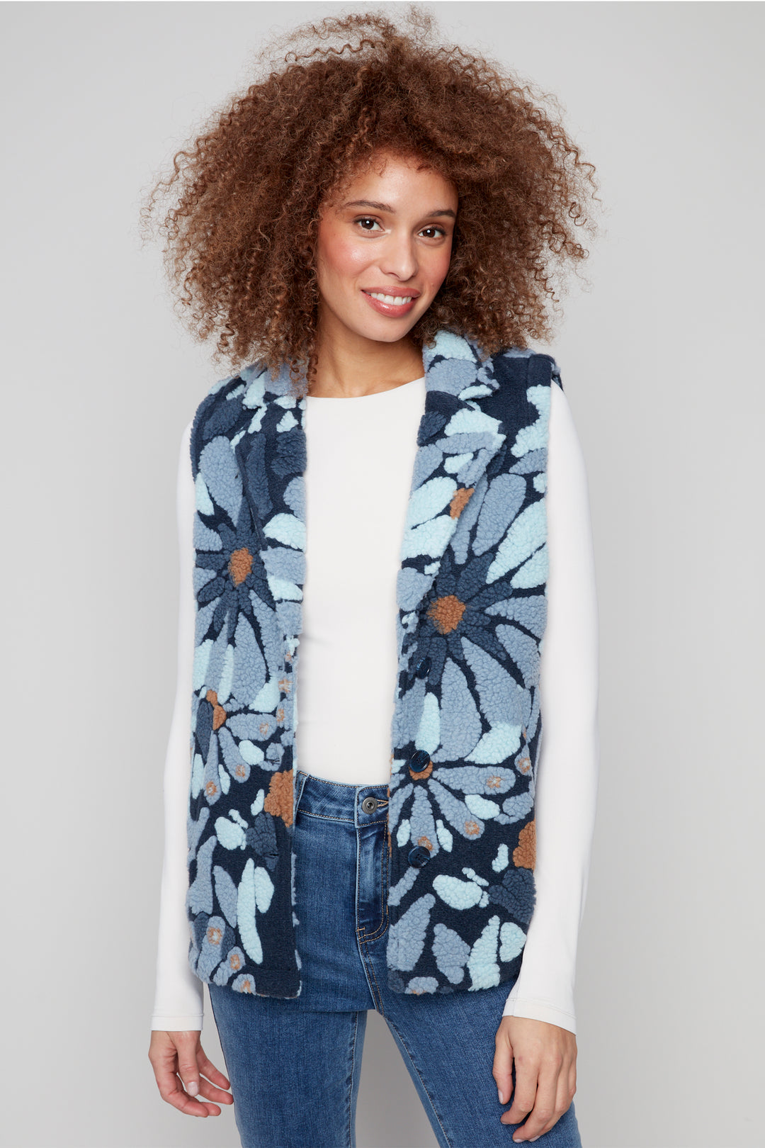 Charlie B Fall 2025 Its soft fleece fabric and front buttons make it easy to layer on those crisp early fall days. The bright flower pattern adds a playful pop to any outfit, perfect for bringing a little sunshine wherever you go!