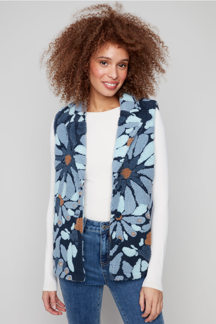 Charlie B Fall 2025 Its soft fleece fabric and front buttons make it easy to layer on those crisp early fall days. The bright flower pattern adds a playful pop to any outfit, perfect for bringing a little sunshine wherever you go!