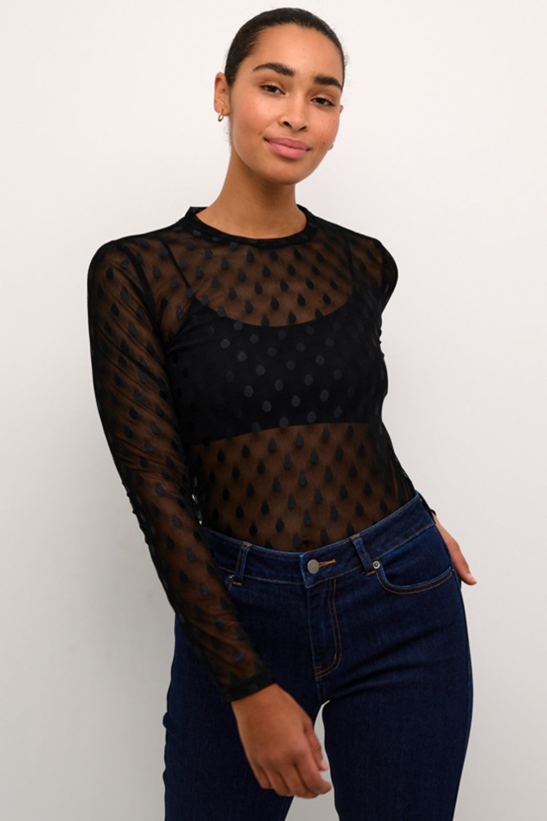 Kaffe Fall 2024  The airy mesh fabric adds a touch of sophistication to this round neck top, while the dotted print design adds a playful twist. 