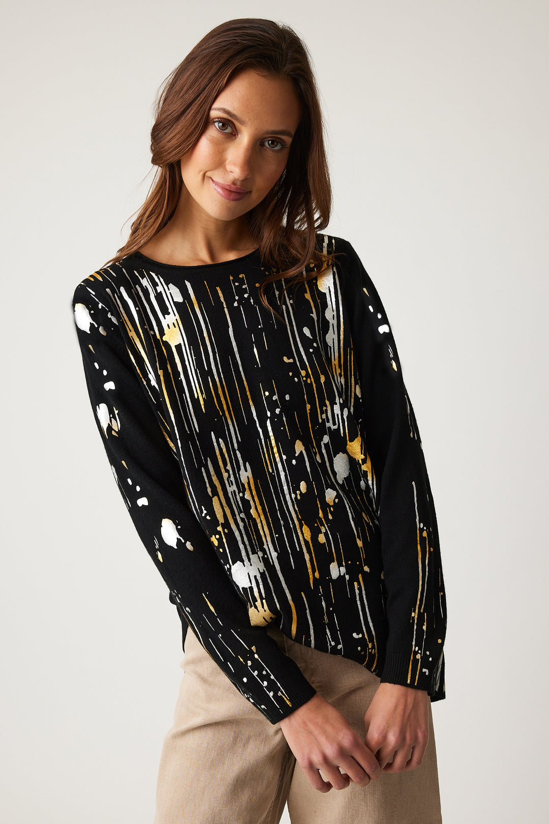 Parkhurst Fall 2024  With a round neckline and contrast back, this pull over also features a unique abstract drip design on the front and sleeves. 