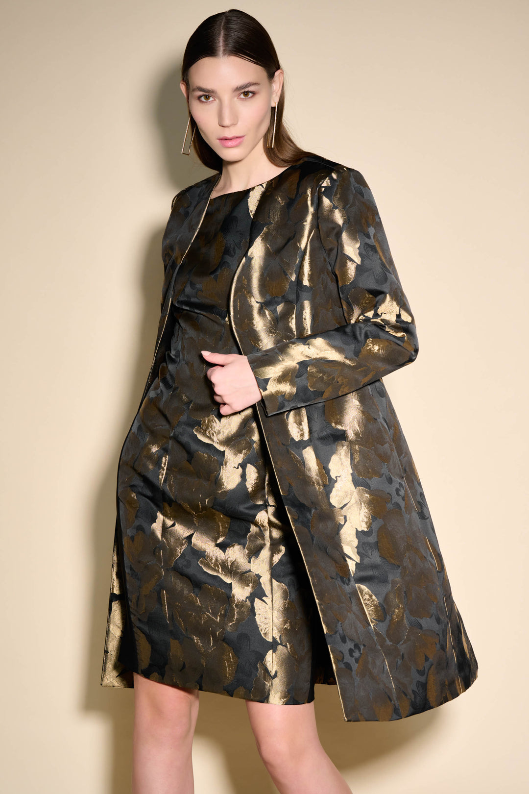 It features an open style light coat and an all-over foil leaf print that adds a glossy golden shine,