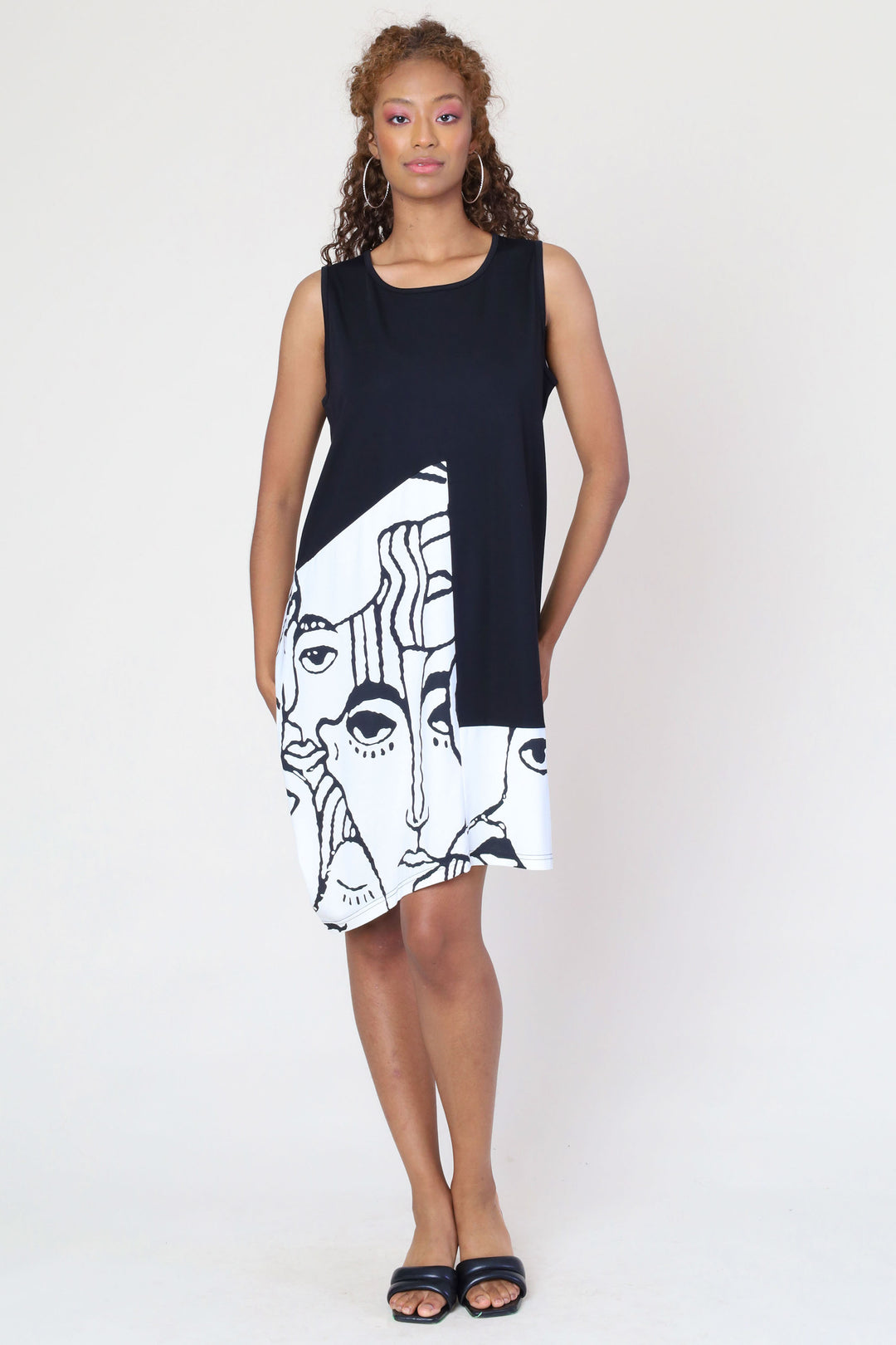 Funsport Summer 2024 Featuring an abstract face print that's sure to turn heads and a flattering boat neckline. The uneven double stitch hem adds a playful twist to this knee-length dress