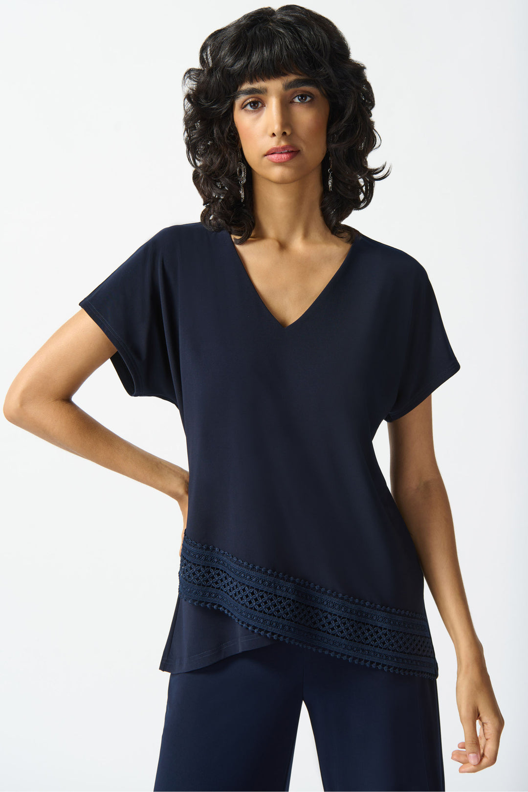 Indulge in style with our V-Neck Top featuring a sharp cut and lovely lace hem for a touch of sophistication. 